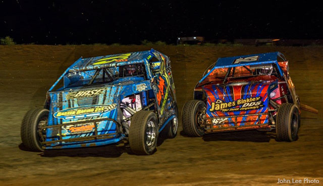 Shad Badder (73b) and Danny Scrogham (92) race side-by-side at Central Missouri Speedway in USRA Modified action.