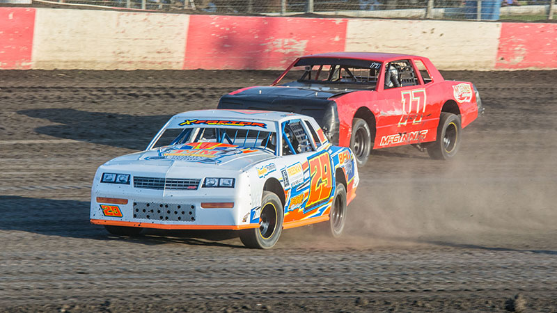Nate Barnes (28) and Kevin McGinnis (17) battle in Holley USRA Stock Car action at the Lakeside Speedway in Kansas City, Kan. (Lisa Burlington Photo)