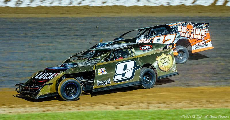 Evan Hubert (9) duels with USRA Modified points leader Darron Fuqua during a feature race at Lucas Oil Speedway.