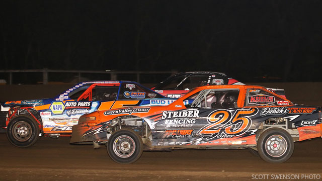 Mitch Hovden (15), Dan Jones (25) and Dillon Anderson (outside) battle three-wide for the lead in the Holley USRA Stock Car feature Friday night at the Fayette County Speedway.
