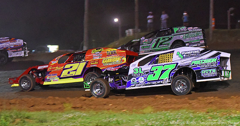 Jackie Dalton (21) battles with Wesley Long (37) and Juston Comer (112) in USRA B-Mod action at the Springfield Raceway.